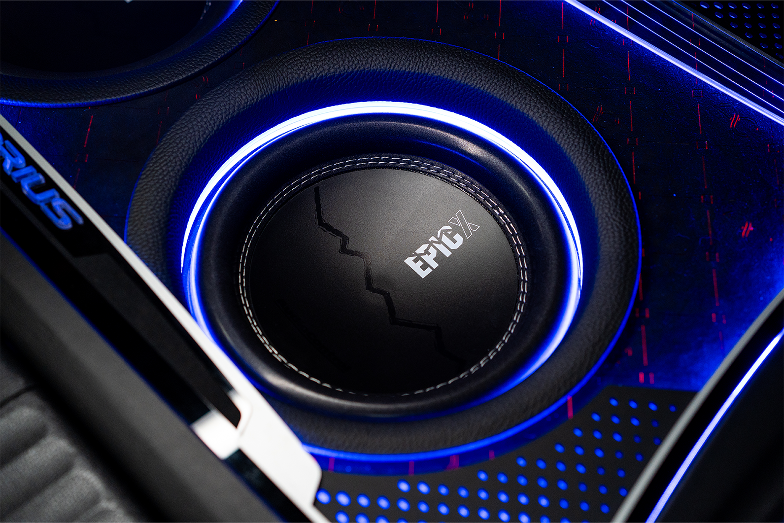 Close-up of a car subwoofer with 'EPICX' branding and blue lighting.