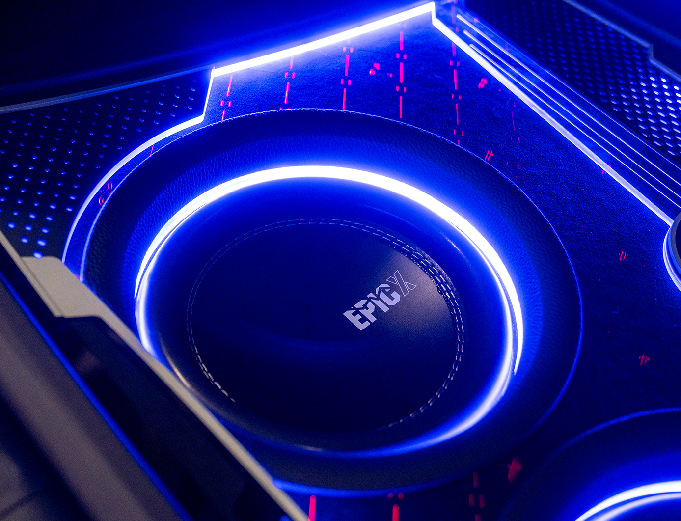 Close-up of a prius trunk with blue LED lighting and 'EpicX' branding on the car subwoofer.
