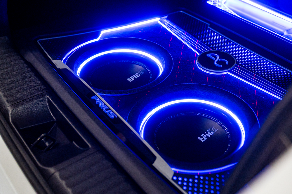 Car subwoofers with blue LED lighting and 'EPICX' branding.